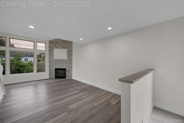 1730 E Woodruff Ave, Hazel Park, MI 48030 - unfurnished living room with wood finished floors, recessed lighting, and a stone fireplace