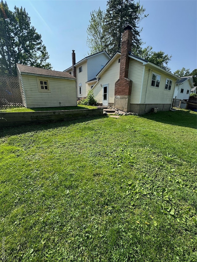 338 Green, Perry, MI 48872 - back of property featuring a lawn and a chimney