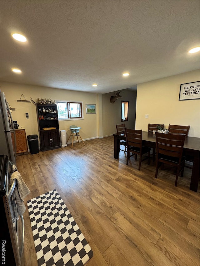 338 Green, Perry, MI 48872 - dining area featuring hardwood / wood-style flooring, a textured ceiling, and recessed lighting