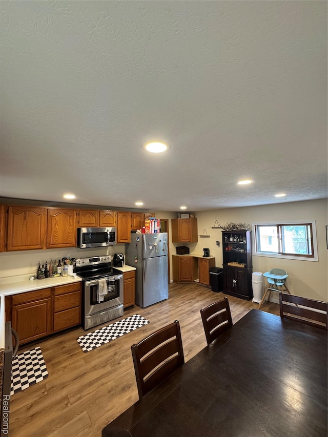 338 Green, Perry, MI 48872 - kitchen featuring stainless steel appliances, brown cabinets, light wood finished floors, light countertops, and recessed lighting