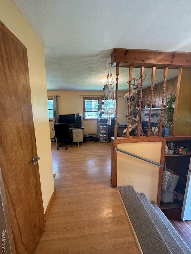 338 Green, Perry, MI 48872 - corridor featuring wood finished floors, a desk, and a textured ceiling