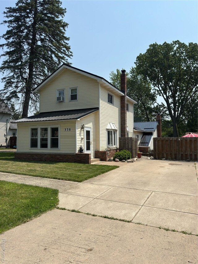 338 Green, Perry, MI 48872 - view of front of home with a metal roof and a chimney