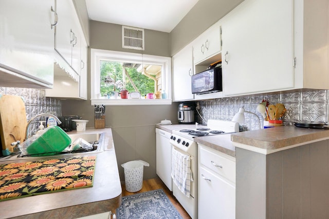 317 E Chart St, Plainwell, MI 49080 - kitchen featuring white appliances, white cabinetry, backsplash, wood finished floors, and light countertops