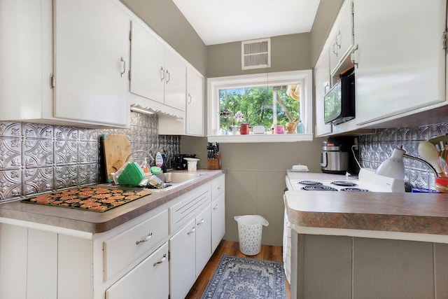 317 E Chart St, Plainwell, MI 49080 - kitchen featuring tasteful backsplash, light wood-style flooring, white cabinetry, light countertops, and white electric stove