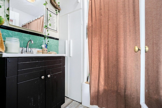 317 E Chart St, Plainwell, MI 49080 - full bath with vanity, curtained shower, and wood finished floors
