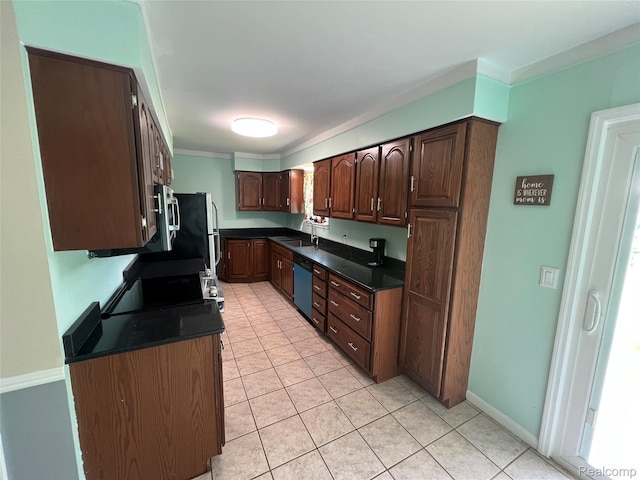 6197 Sober Rd, Fowlerville, MI 48836 - kitchen with dark countertops, light tile patterned flooring, stove, dishwashing machine, and ornamental molding