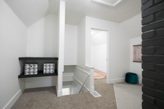 1100 W Laketon Ave, Muskegon, MI 49441 - hall with carpet floors, an upstairs landing, and a textured ceiling