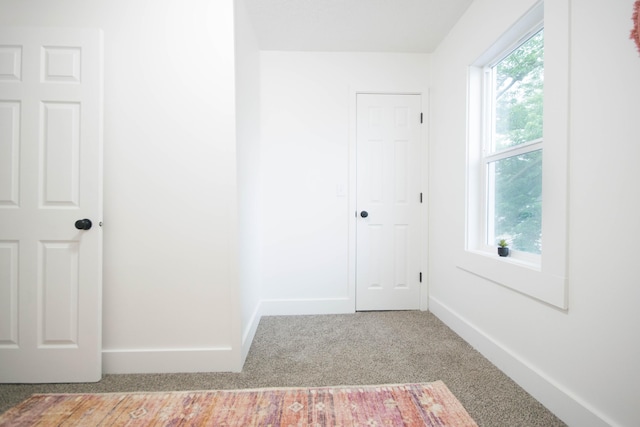 1100 W Laketon Ave, Muskegon, MI 49441 - unfurnished bedroom featuring carpet floors and baseboards