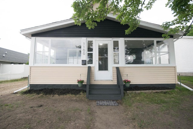 1100 W Laketon Ave, Muskegon, MI 49441 - view of front facade with a sunroom and entry steps