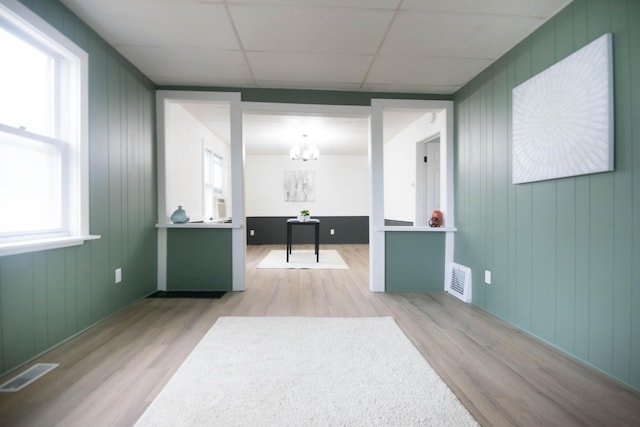 1100 W Laketon Ave, Muskegon, MI 49441 - hallway featuring wood finished floors, a chandelier, and a drop ceiling