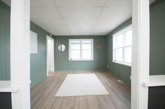 1100 W Laketon Ave, Muskegon, MI 49441 - empty room with a paneled ceiling and wood finished floors