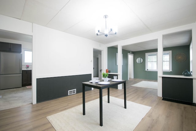 1100 W Laketon Ave, Muskegon, MI 49441 - office space with a chandelier, light wood-style floors, and a wainscoted wall