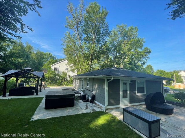 1485 Paramount St, Novi, MI 48377 - back of property with a patio area, a gazebo, an outdoor living space, a hot tub, and a lawn