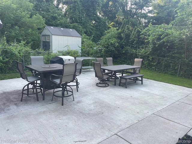1485 Paramount St, Novi, MI 48377 - view of patio / terrace featuring outdoor dining area, a shed, and a forest view
