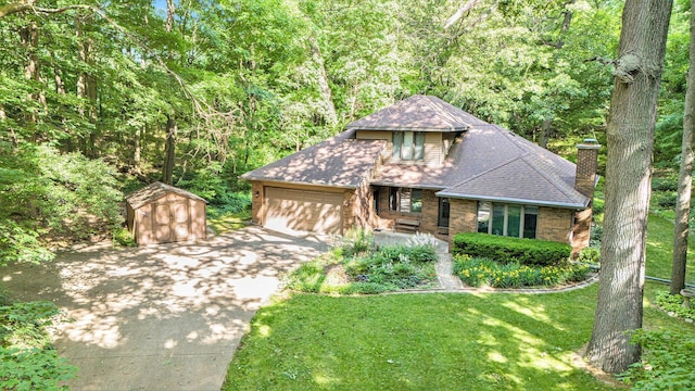 1769 Maple Ln, Benton Harbor, MI 49022 - view of front of property with a shed, concrete driveway, an attached garage, a front lawn, and roof with shingles