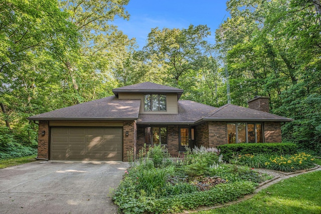 1769 Maple Ln, Benton Harbor, MI 49022 - view of front of property featuring concrete driveway, an attached garage, brick siding, and a chimney