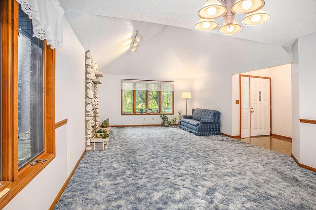 1769 Maple Ln, Benton Harbor, MI 49022 - unfurnished room with a chandelier, carpet flooring, lofted ceiling, and a textured ceiling