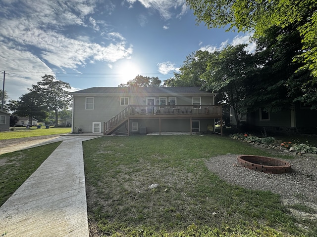 313 N Matteson St, Bronson, MI 49028 - rear view of property with stairs, a yard, a deck, and a fire pit