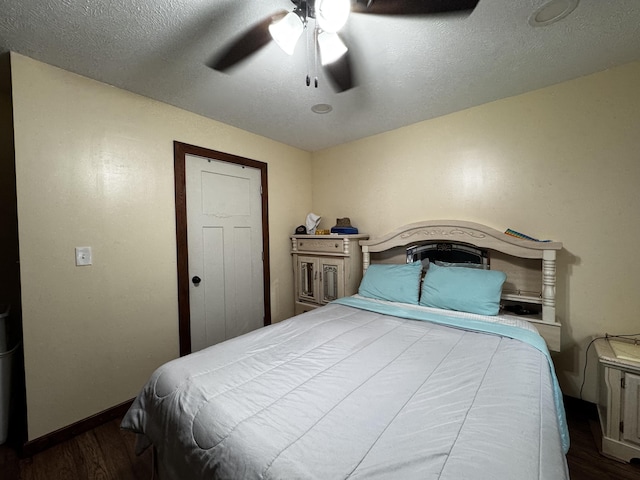 313 N Matteson St, Bronson, MI 49028 - bedroom featuring dark wood finished floors, ceiling fan, and a textured ceiling