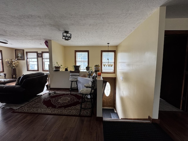 313 N Matteson St, Bronson, MI 49028 - living area with wood finished floors and a textured ceiling