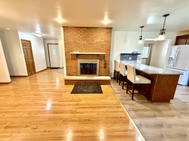 10844 Judd Rd, Willis, MI 48191 - living area with light wood-style flooring and a fireplace