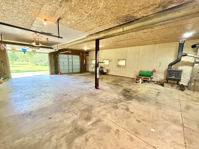 10844 Judd Rd, Willis, MI 48191 - garage with a wood stove and a garage door opener