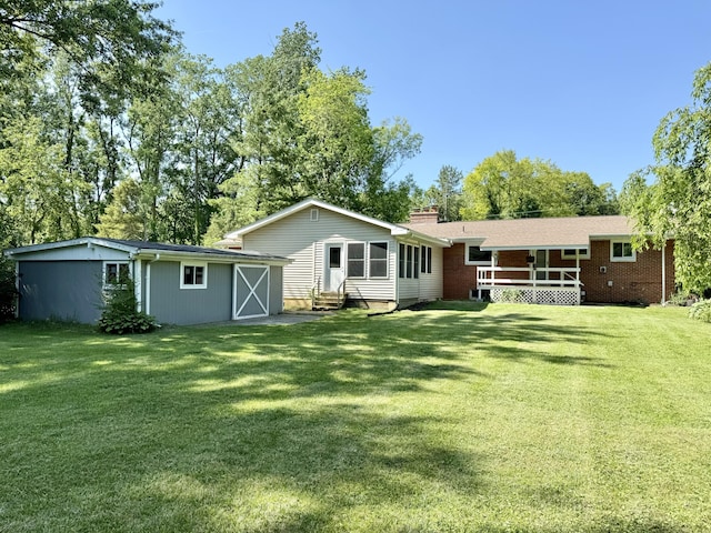 10844 Judd Rd, Willis, MI 48191 - rear view of property featuring entry steps, an outdoor structure, a yard, and a chimney