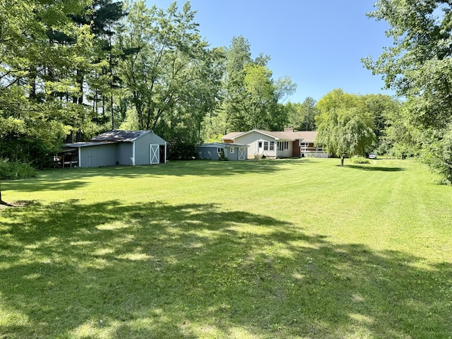 10844 Judd Rd, Willis, MI 48191 - view of grassy yard with an outbuilding and view of scattered trees