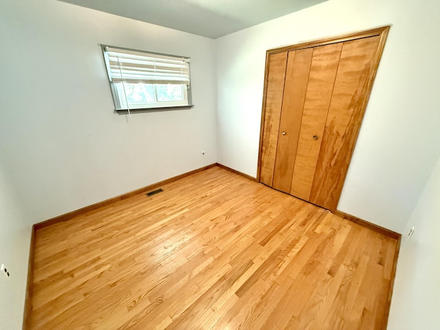 10844 Judd Rd, Willis, MI 48191 - unfurnished bedroom featuring light wood-style flooring and a closet