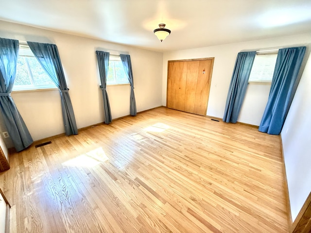 10844 Judd Rd, Willis, MI 48191 - unfurnished bedroom with light wood-type flooring and baseboards