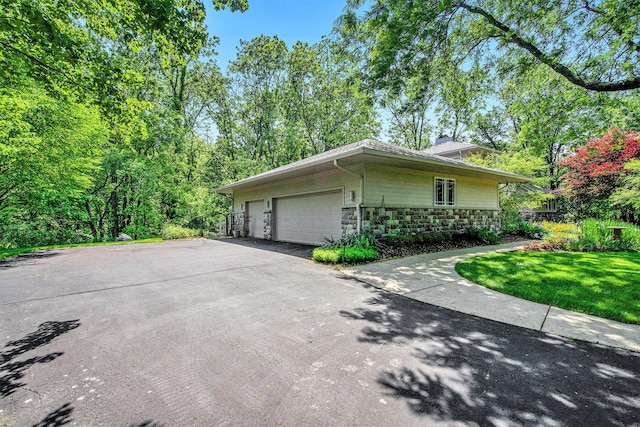 8023 Trail Rdg, Dexter, MI 48130 - view of property exterior with stone siding and a chimney