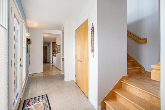 8023 Trail Rdg, Dexter, MI 48130 - hall featuring stairs and light tile patterned floors