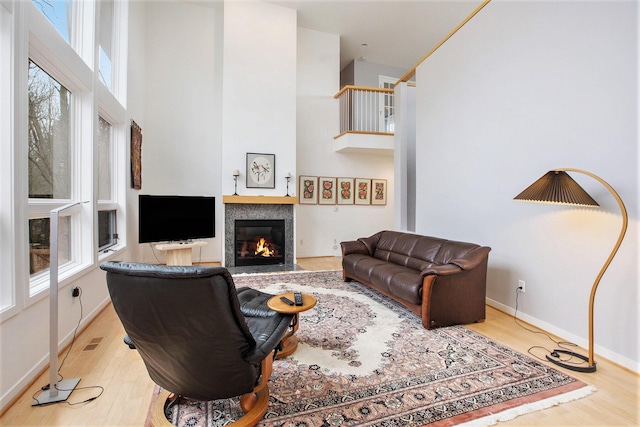 8023 Trail Rdg, Dexter, MI 48130 - living room featuring a high ceiling, wood finished floors, and a fireplace with flush hearth