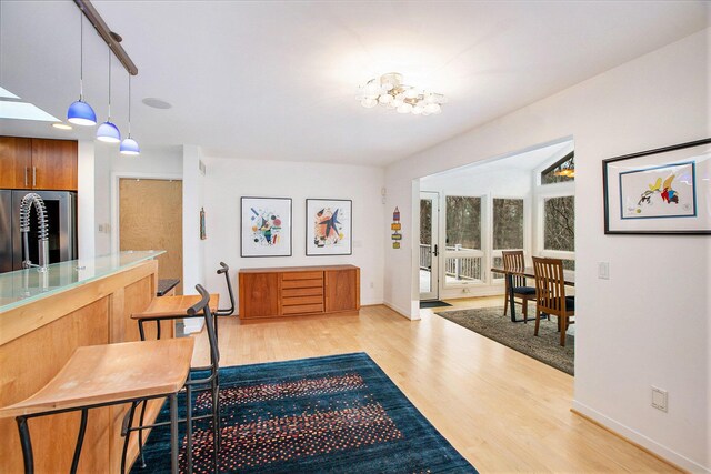 8023 Trail Rdg, Dexter, MI 48130 - entrance foyer featuring light wood finished floors and a chandelier