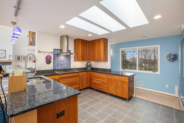 8023 Trail Rdg, Dexter, MI 48130 - kitchen with a peninsula, wall chimney exhaust hood, a skylight, and recessed lighting