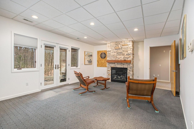 8023 Trail Rdg, Dexter, MI 48130 - living area with carpet floors, french doors, a stone fireplace, a drop ceiling, and recessed lighting