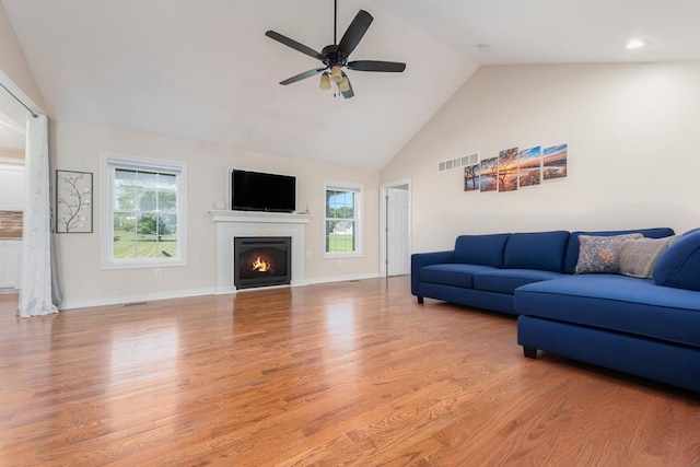 575 Autumns Way Blvd, Kalamazoo, MI 49009 - living area with light wood-style floors, ceiling fan, healthy amount of natural light, high vaulted ceiling, and a warm lit fireplace