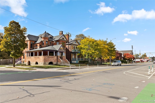 5216 Avery St, Detroit, MI 48208 - view of asphalt street with sidewalks, curbs, and street lights
