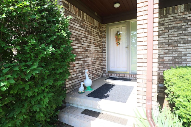 8141 N Elms Rd, Flushing, MI 48433 - view of exterior entry featuring brick siding and a porch