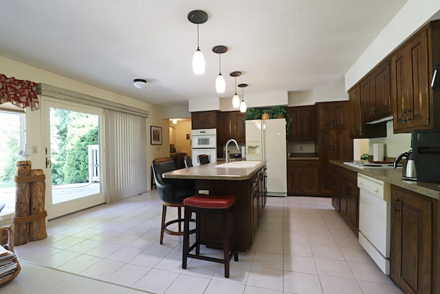 8141 N Elms Rd, Flushing, MI 48433 - kitchen with white appliances, dark brown cabinetry, a kitchen bar, pendant lighting, and a textured ceiling