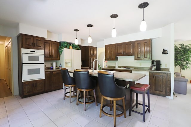 8141 N Elms Rd, Flushing, MI 48433 - kitchen featuring white appliances, a kitchen bar, pendant lighting, and light tile patterned floors