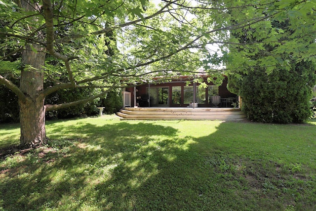 8141 N Elms Rd, Flushing, MI 48433 - view of grassy yard with a deck