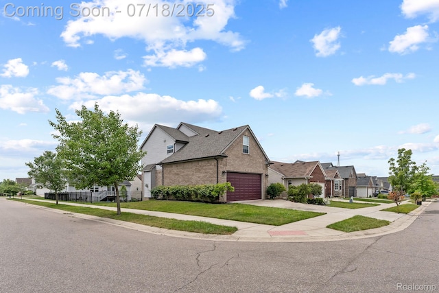 4074 Peach Tree Ln, Howell, MI 48843 - view of front facade featuring a residential view, brick siding, concrete driveway, and a front lawn