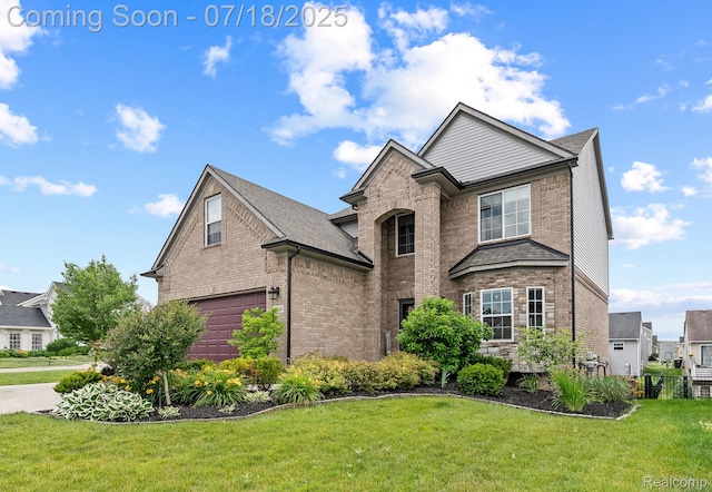 4074 Peach Tree Ln, Howell, MI 48843 - view of front of property featuring brick siding, a front yard, and a garage