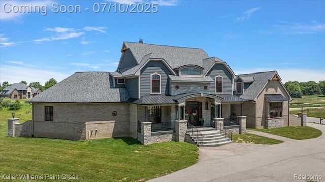 6295 Canter Creek Trl, Grand Blanc, MI 48439 - french country style house with a standing seam roof, a front lawn, a metal roof, and a porch