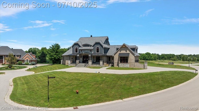 6295 Canter Creek Trl, Grand Blanc, MI 48439 - french country inspired facade featuring stone siding, curved driveway, and a front yard