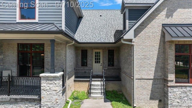 6295 Canter Creek Trl, Grand Blanc, MI 48439 - doorway to property featuring a standing seam roof, roof with shingles, a metal roof, and brick siding
