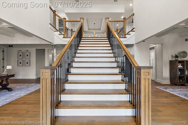 6295 Canter Creek Trl, Grand Blanc, MI 48439 - staircase featuring a towering ceiling and wood finished floors