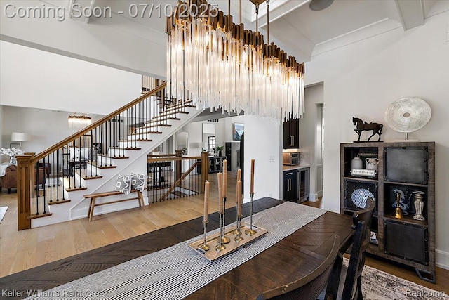 6295 Canter Creek Trl, Grand Blanc, MI 48439 - dining space with wood-type flooring, stairs, beam ceiling, beverage cooler, and a high ceiling
