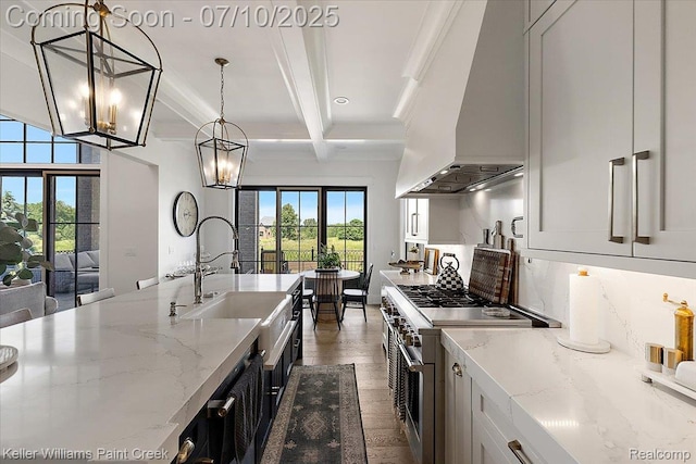 6295 Canter Creek Trl, Grand Blanc, MI 48439 - kitchen with custom range hood, high end stainless steel range, beamed ceiling, a chandelier, and dark wood-style flooring
